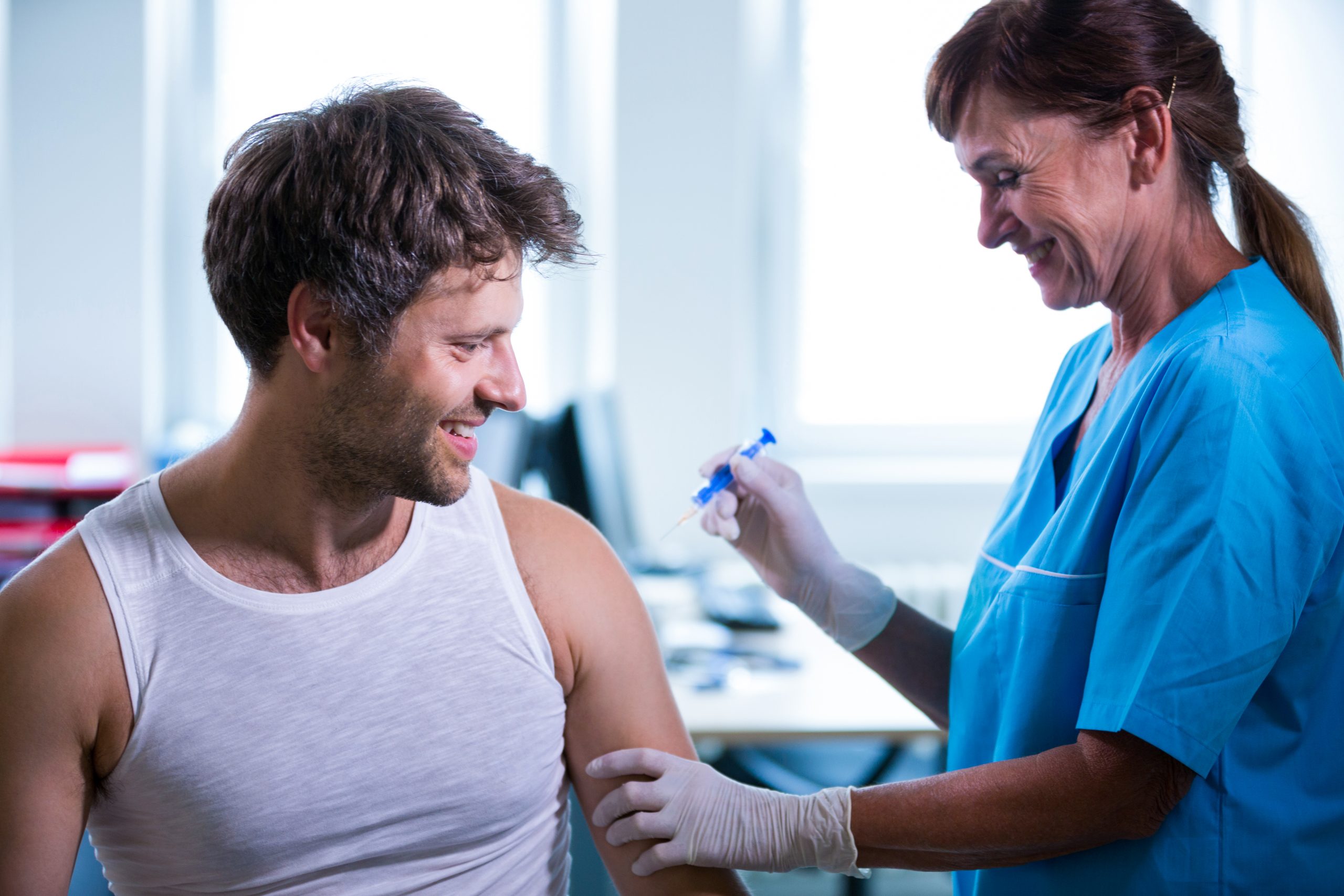 doctor giving an injection to a patient